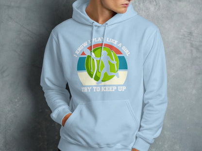 Light blue hoodie with a graphic of a tennis player and text I KNOW I PLAY LIKE A GIRL.
