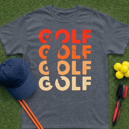 Dark t-shirt with "GOLF" in orange and yellow retro font, laid on grass.