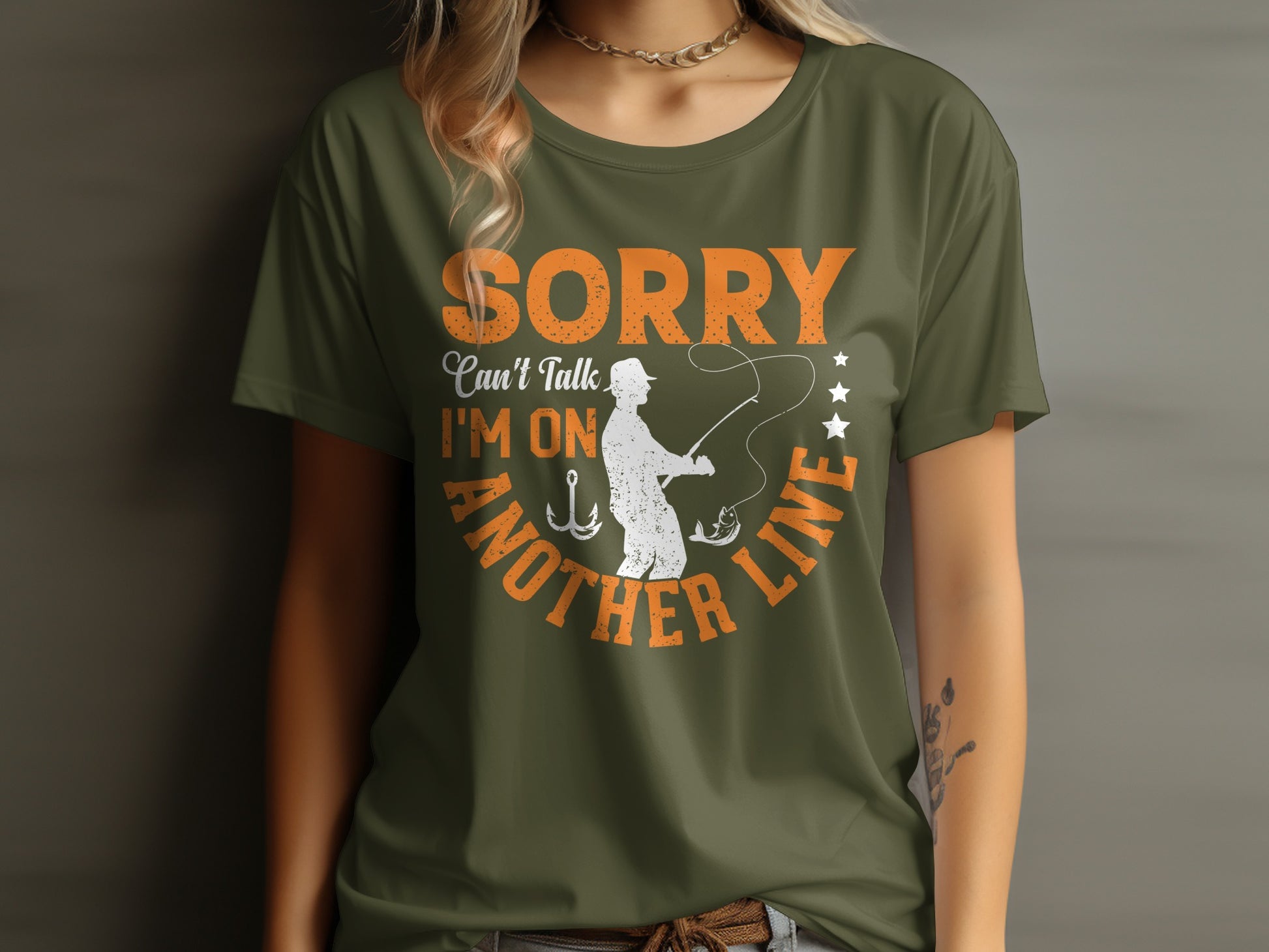 Olive t-shirt with orange text about fishing and a fisherman catching a fish.