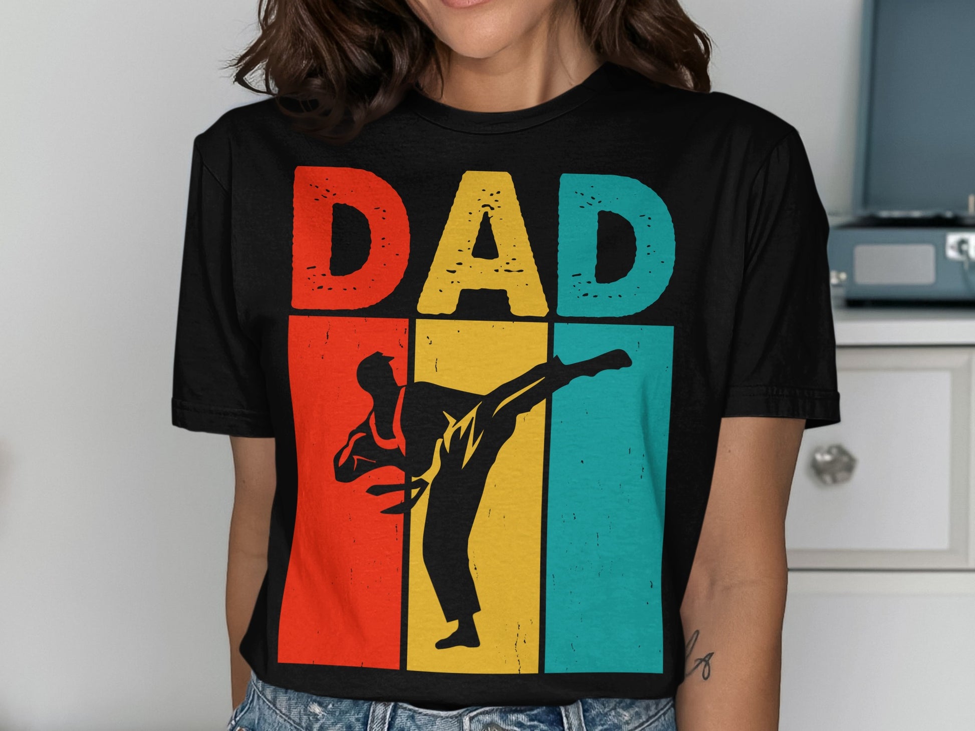 Black t-shirt with "DAD" in colorful block letters above a karate silhouette.