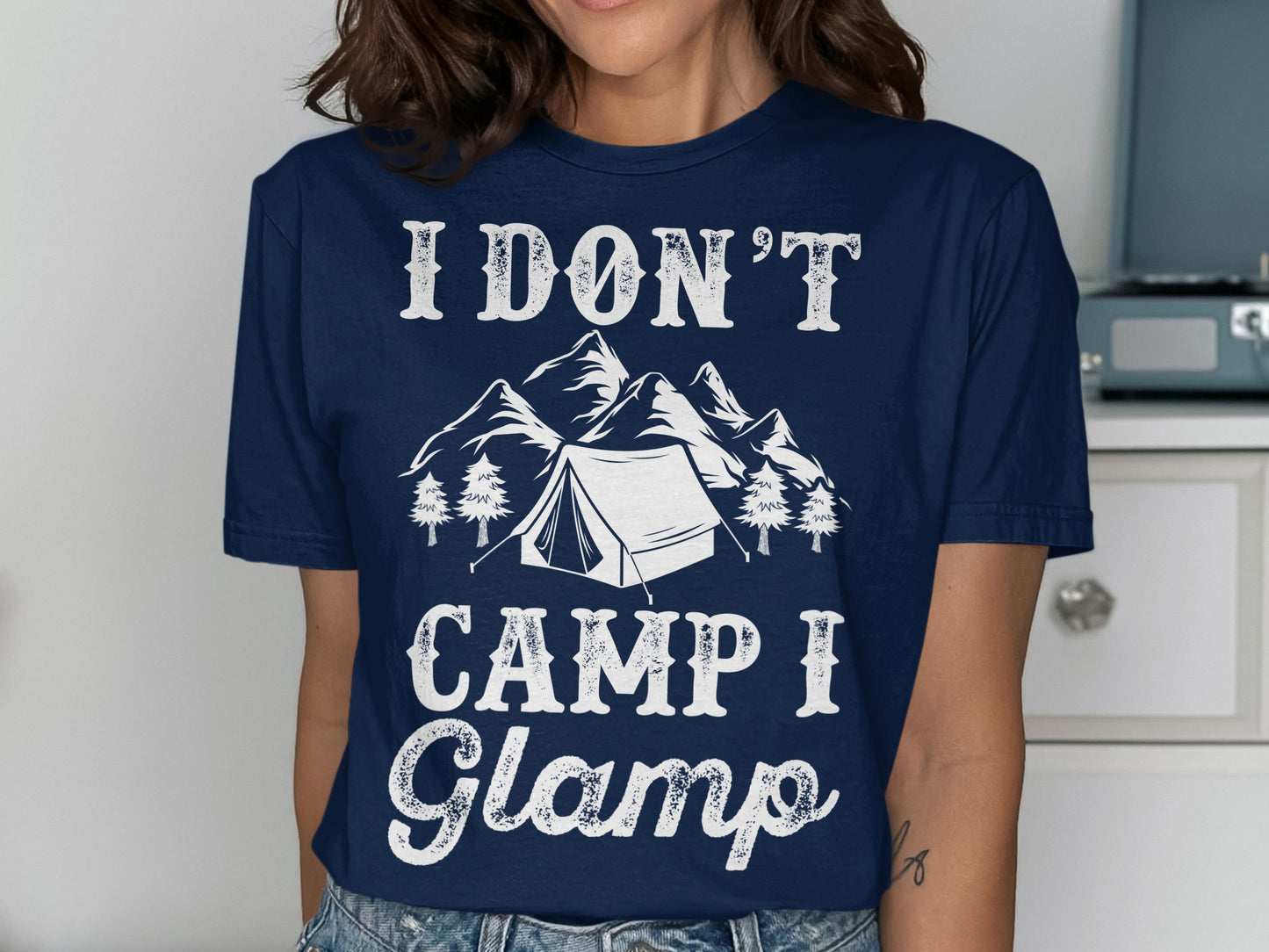 Navy t-shirt with "I DON'T CAMP I Glamp" text and mountain tent graphic.