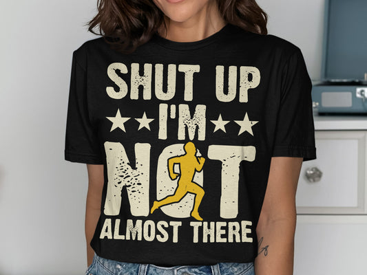 Black t-shirt with "Shut Up I'm Not Almost There" and a running silhouette.