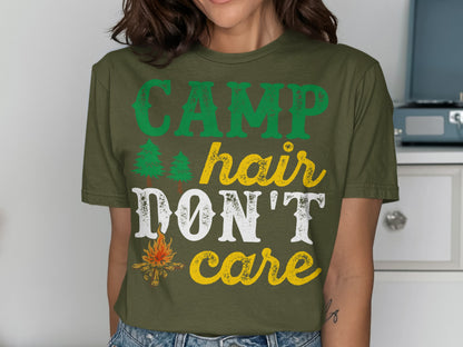 Green t-shirt with "CAMP hair DON'T care" text and small tree and campfire graphics.