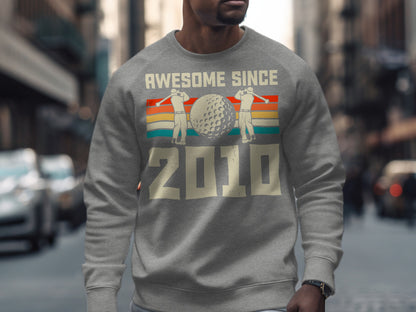 Gray sweatshirt with "Awesome Since 2010" and golf imagery.