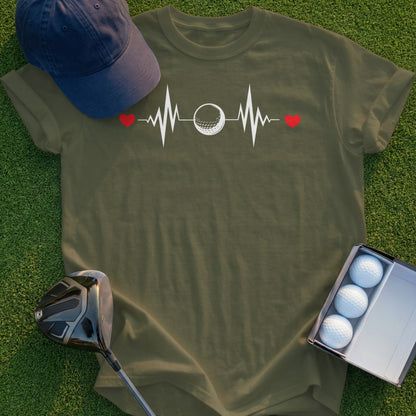 Olive green t-shirt with a golf ball heartbeat graphic and two golf balls in a box.