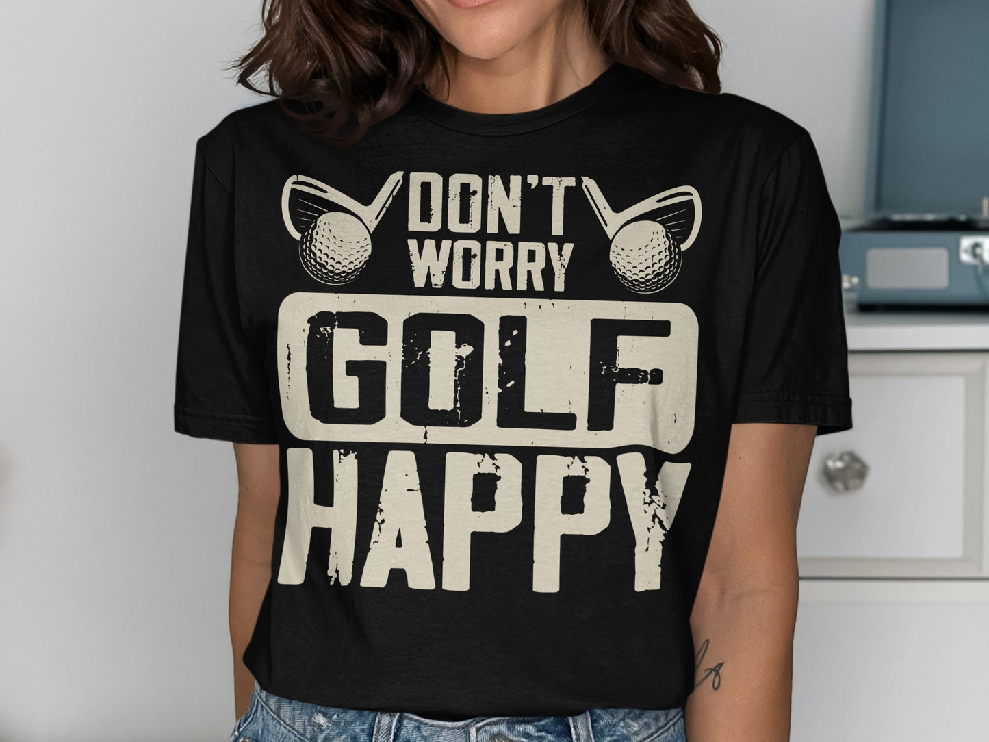 Black t-shirt with "Don't Worry Golf Happy" text and golf balls.