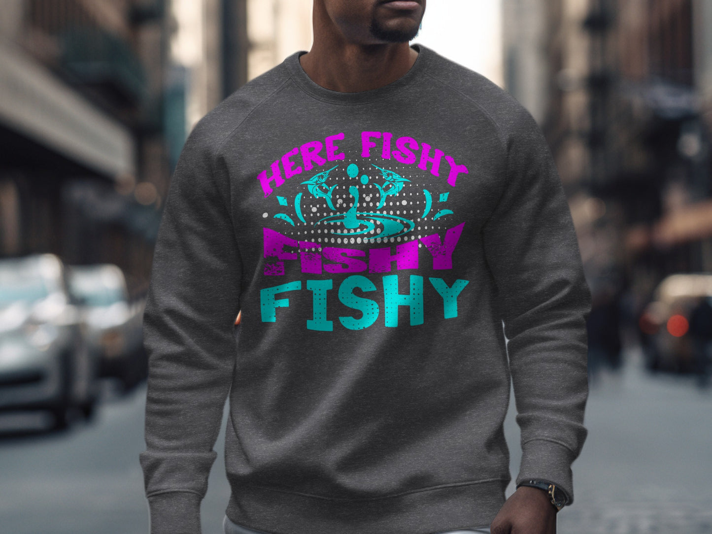 Dark gray crewneck sweatshirt with "HERE FISHY FISHY" text in pink and teal.