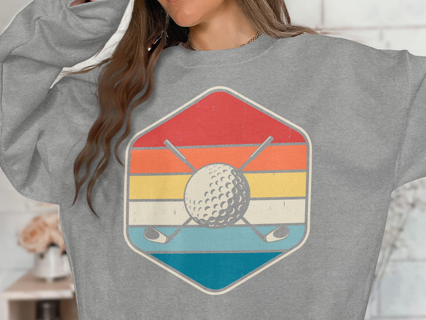Retro golf ball and crossed clubs inside a striped hexagon.