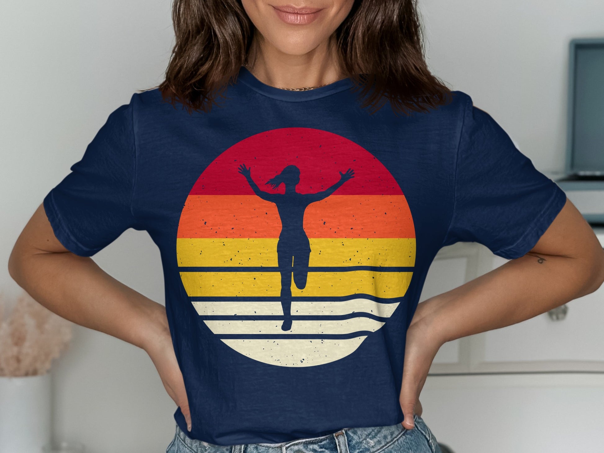 Navy t-shirt with a sunset graphic featuring a running silhouette.