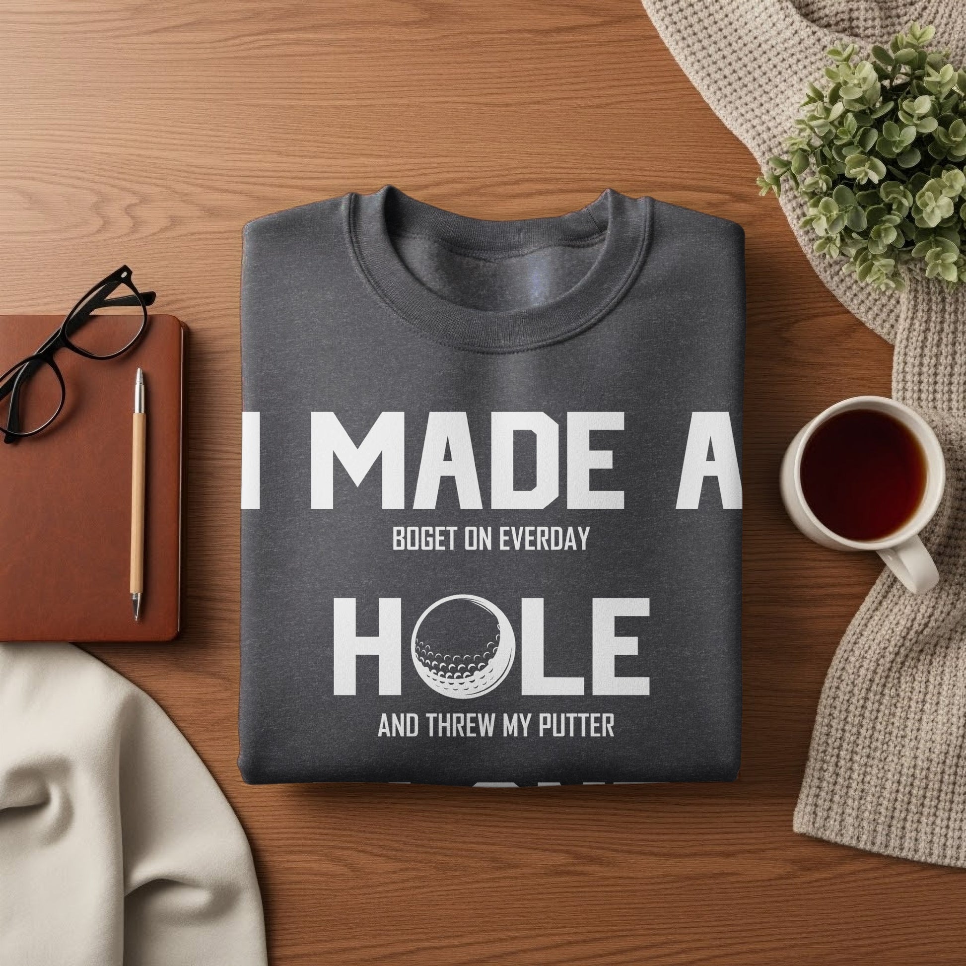 Dark gray sweatshirt with white text reading "I made a bogey on everyday and threw my putter."