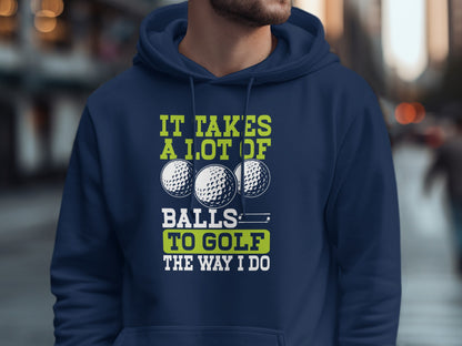 Navy hoodie with "It takes a lot of balls to golf the way I do" and three golf balls.