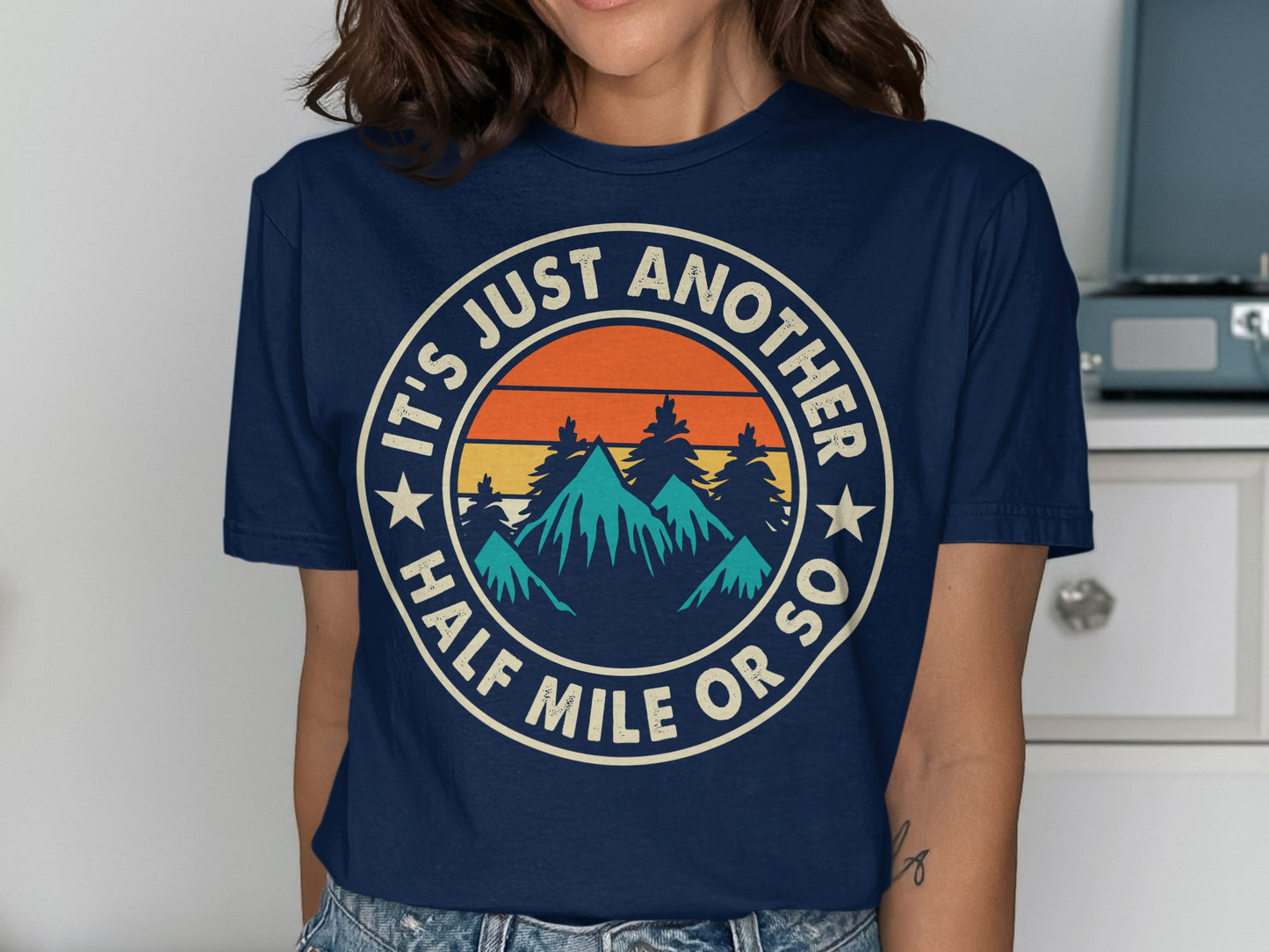 Navy t-shirt with circular graphic, "It's Just Another Half Mile Or So."