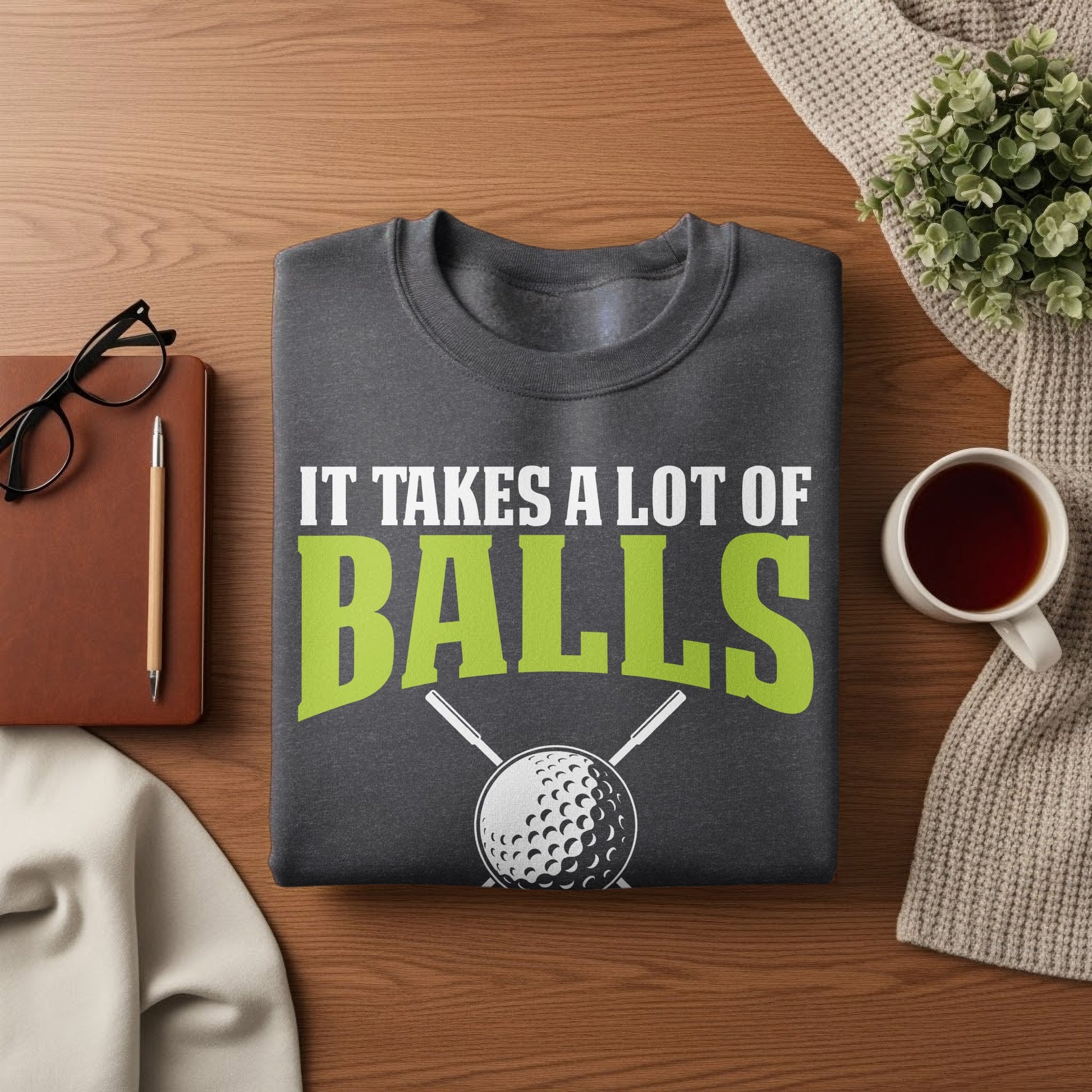 Dark gray sweatshirt with "IT TAKES A LOT OF BALLS" and golf club graphic.