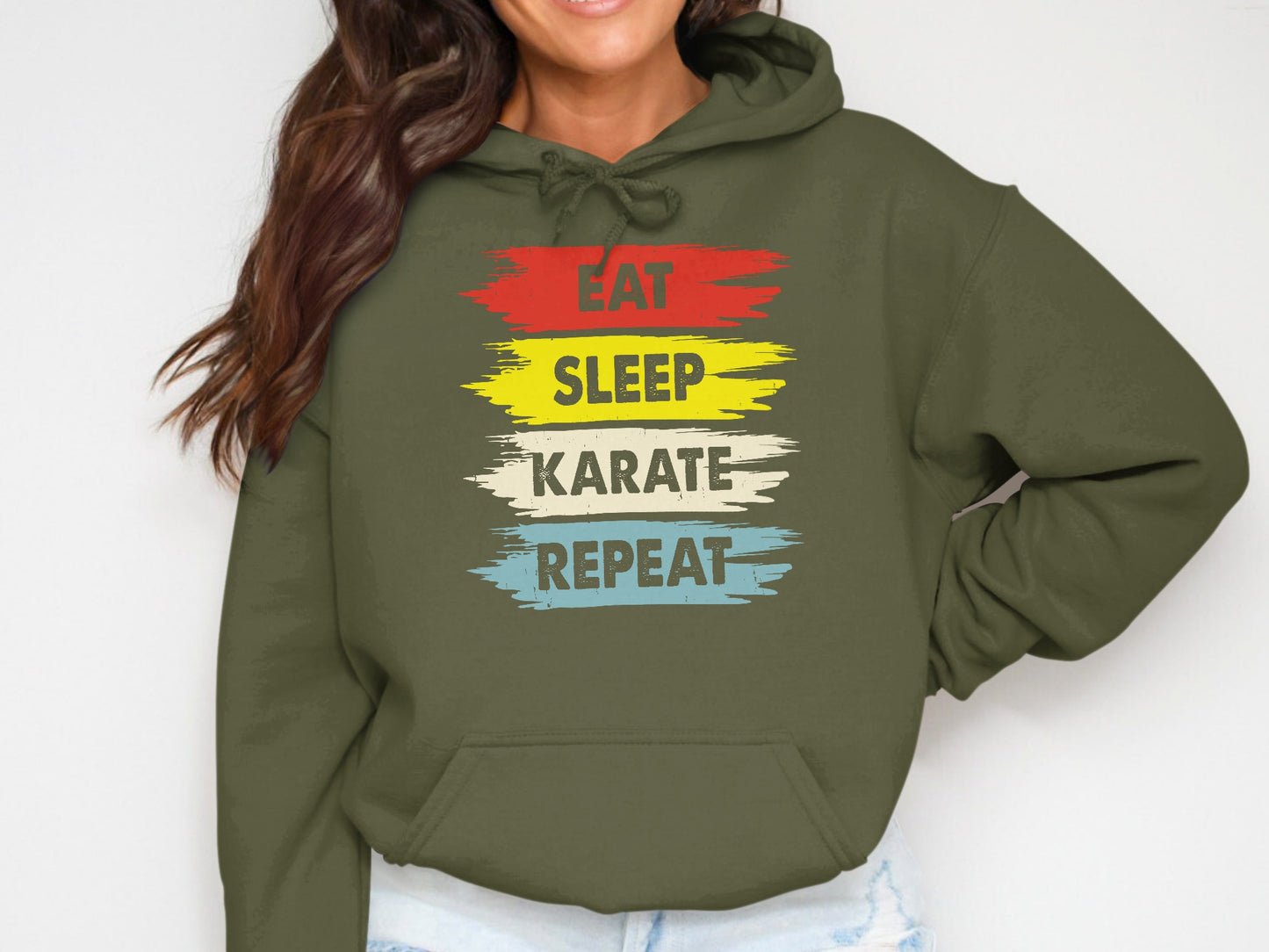 Green hoodie with "EAT SLEEP KARATE REPEAT" in colorful distressed text.