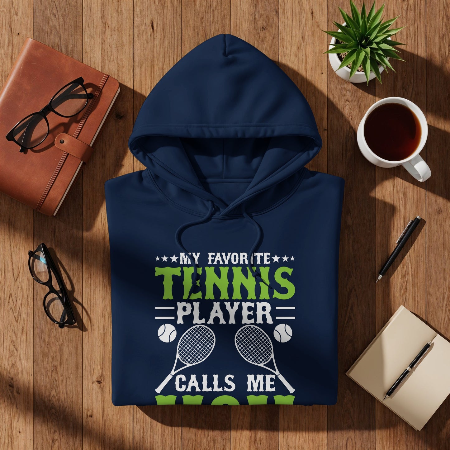 Navy hoodie with "MY FAVORITE TENNIS PLAYER CALLS ME MOM" text and racquets.