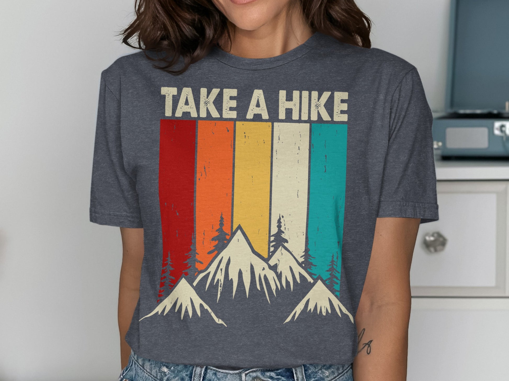 Gray t-shirt with "TAKE A HIKE" text over mountain and forest landscape.