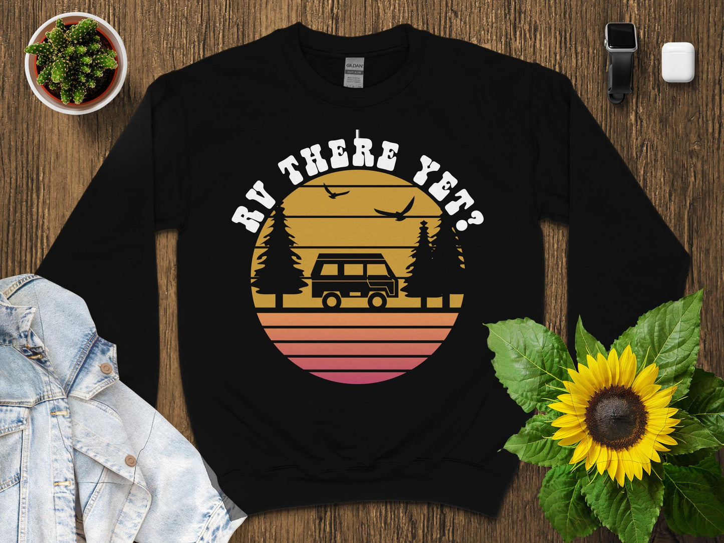 Black sweatshirt with retro sunset graphic, van, trees, and birds, "BY HERE YET?"