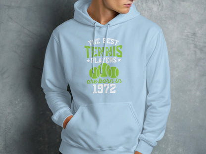 Light blue hoodie with "The best tennis players are born in 1972" text and tennis balls.