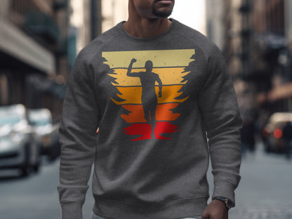 Gray sweatshirt with silhouette of runner against colorful sunset stripes.