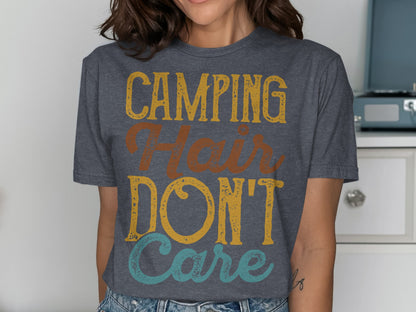 Dark grey t-shirt with yellow, orange, and blue text reading "Camping Hair Don't Care".