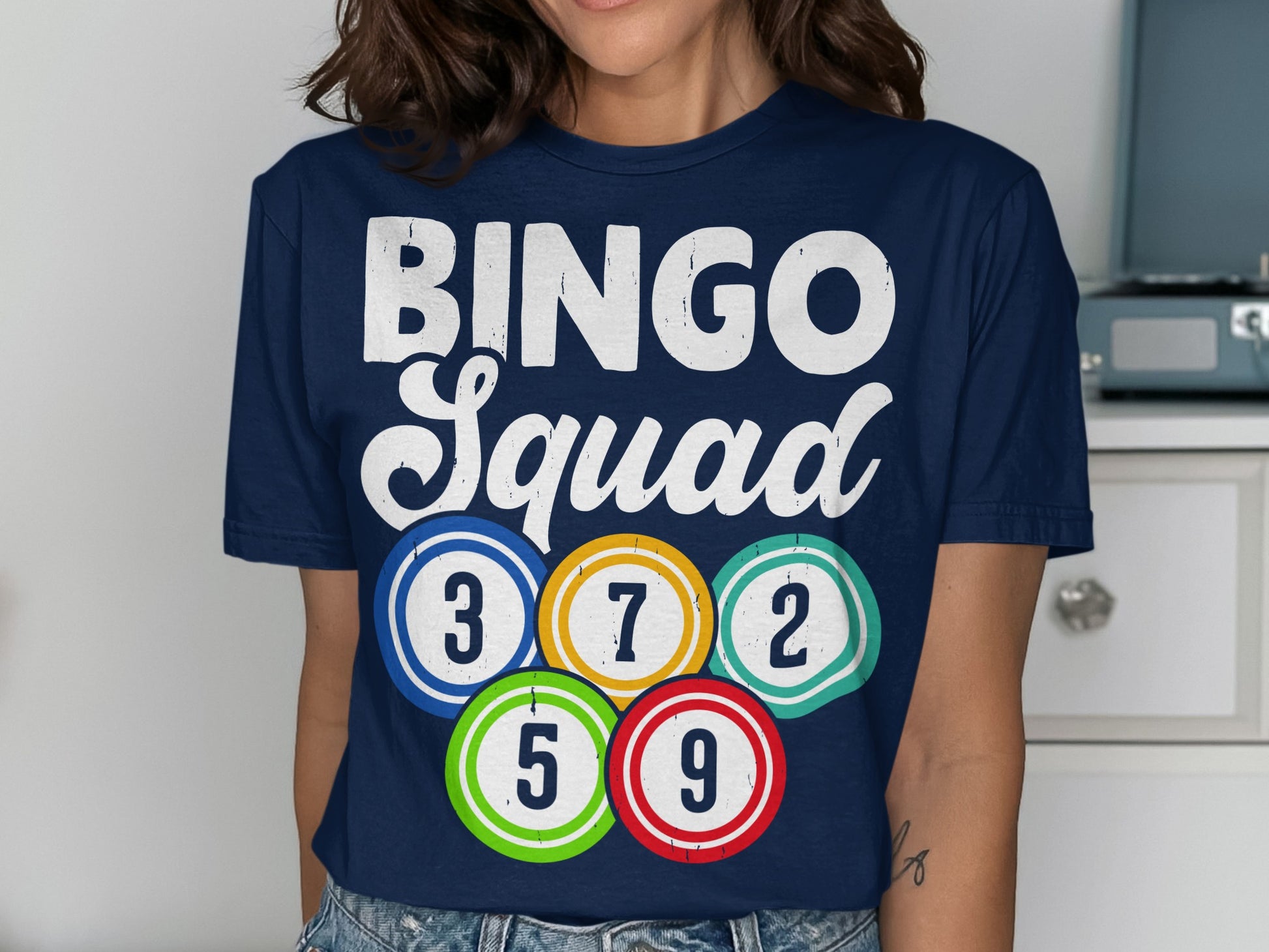 Navy t-shirt with "BINGO Squad" and colorful bingo balls showing numbers 3, 7, 2, 5, and 9.