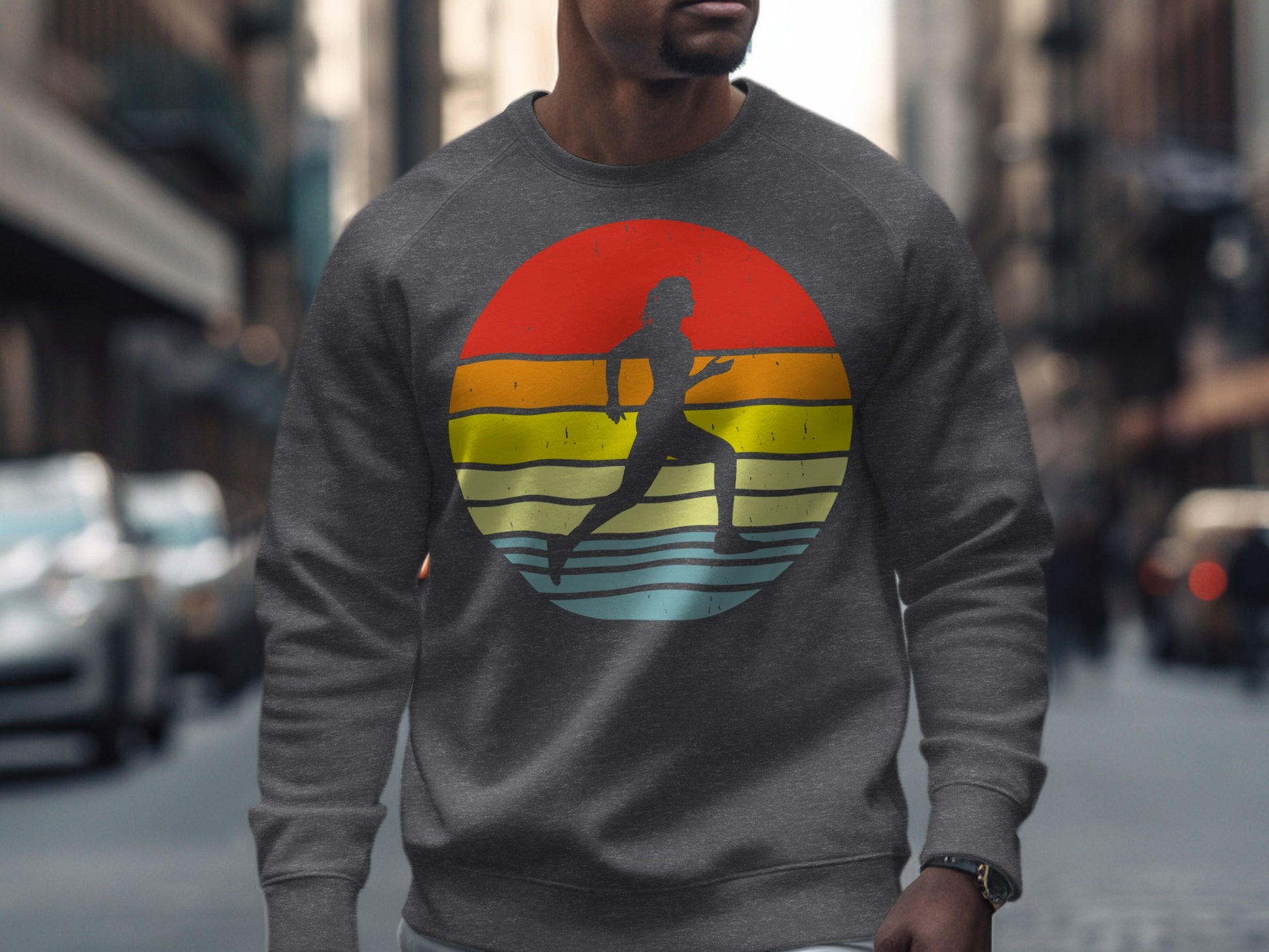 Gray crewneck sweatshirt with runner silhouette against a colorful sunset circle.