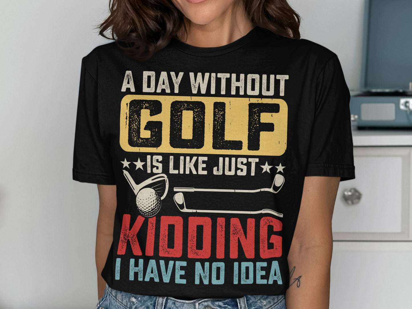 Black t-shirt with "A day without golf is like just kidding I have no idea" text.