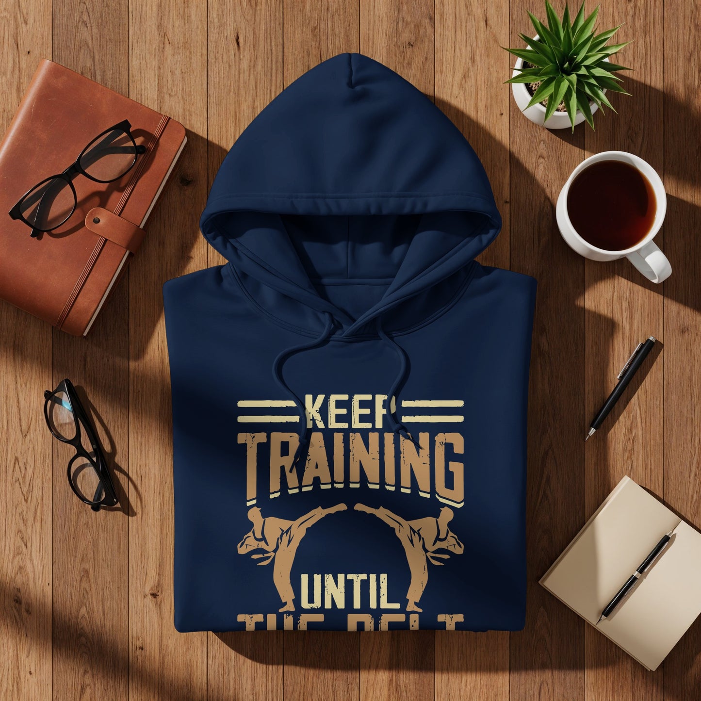 Navy hoodie with "Keep Training Until the Belt" text and graphic.