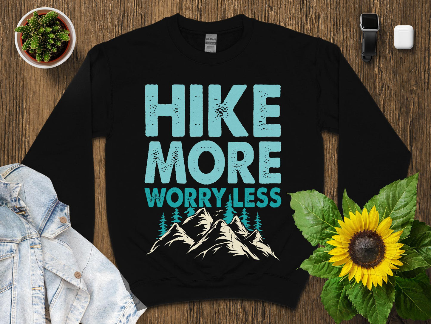 Black sweatshirt with "Hike More Worry Less" text and mountain graphic.