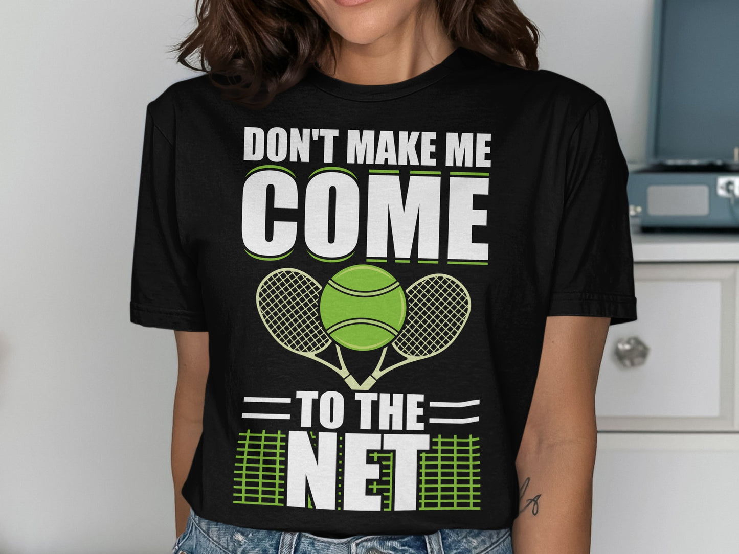 Black t-shirt with "DON'T MAKE ME COME TO THE NET" and tennis graphics.