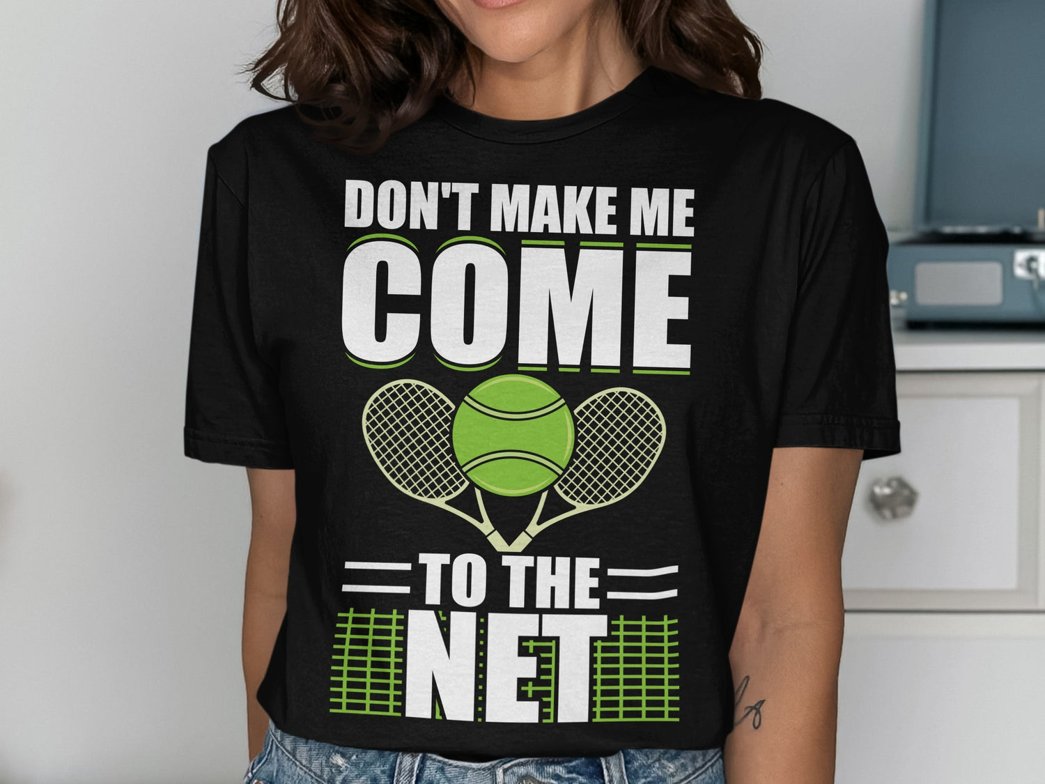 Black t-shirt with "DON'T MAKE ME COME TO THE NET" and tennis graphics.