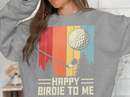 Gray sweatshirt with "HAPPY BIRDIE TO ME" text, golf ball, and vintage stripes.