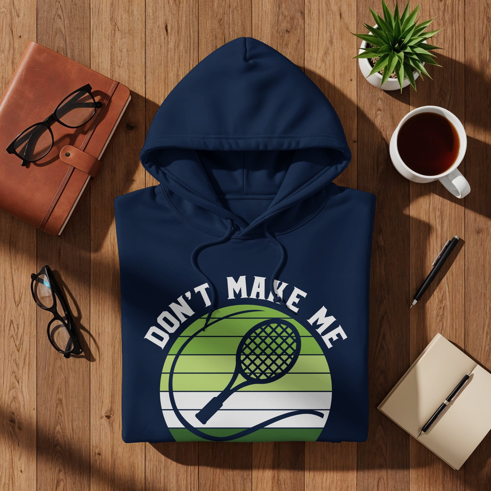 Navy blue hoodie with "Don't Make Me" tennis ball graphic.