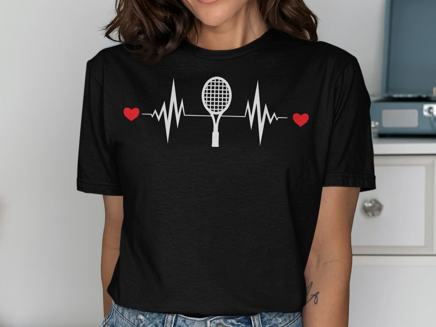 Black t-shirt with white tennis racket and heartbeat design.