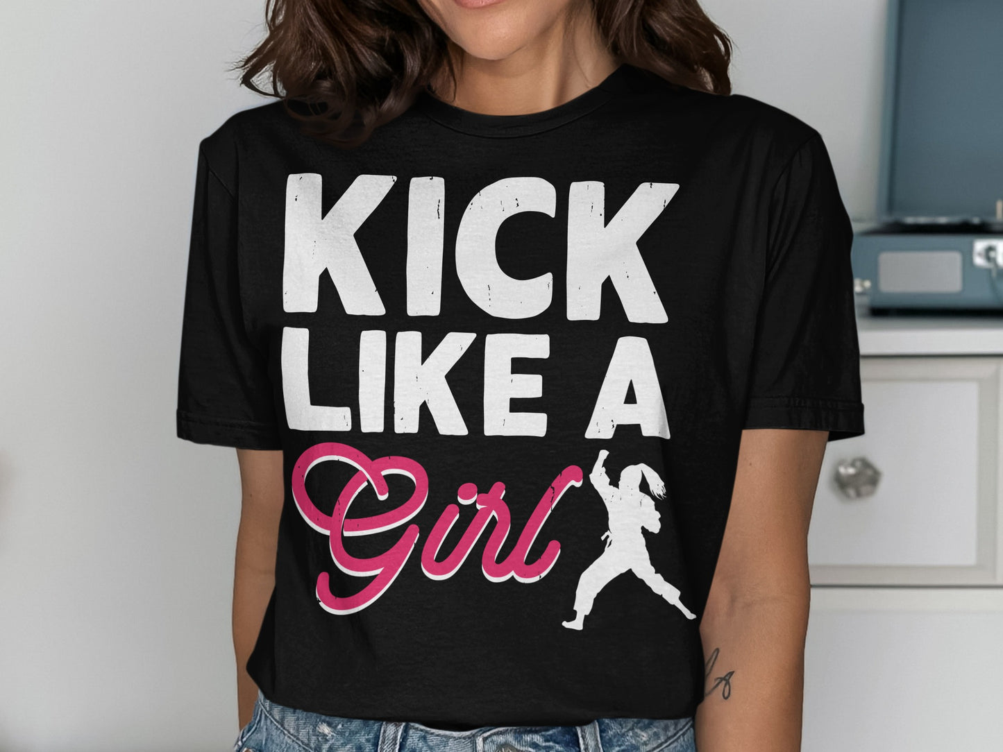 Black t-shirt with "KICK LIKE A Girl" text and silhouette of a martial artist.