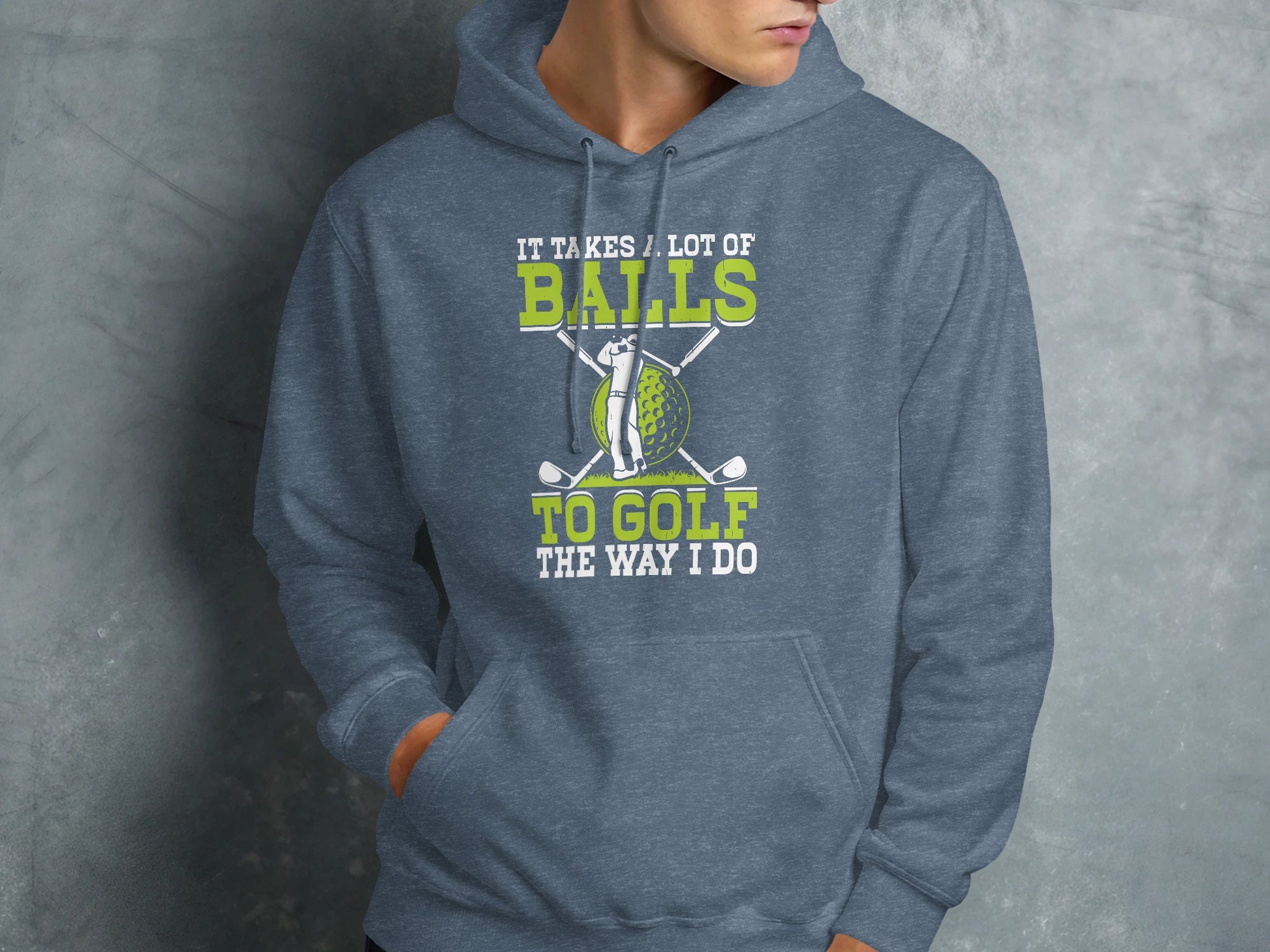 Grey hoodie with golf balls, clubs, and text "It takes a lot of balls to golf the way I do".