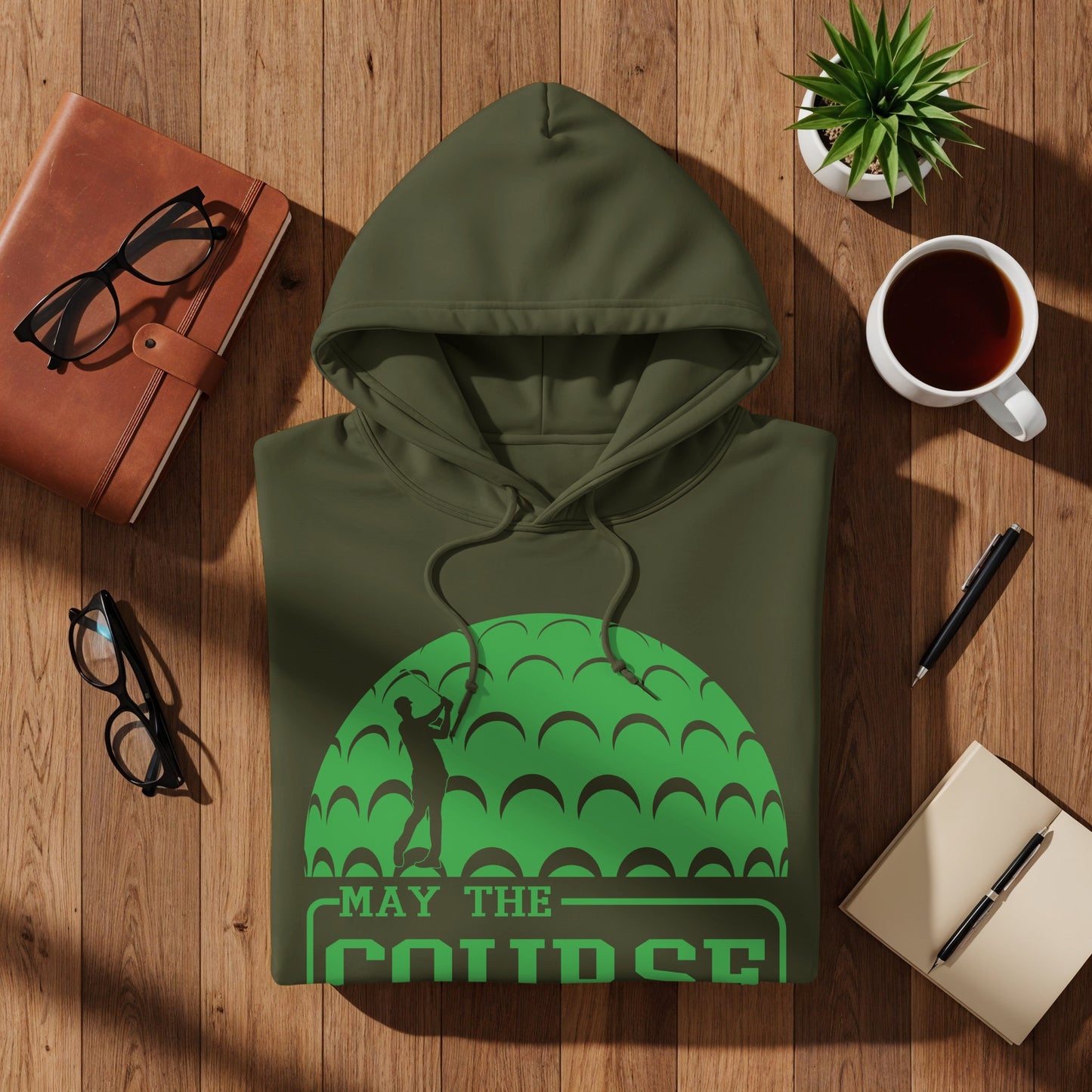 Olive green hoodie with a golf ball graphic and "May the course" text.