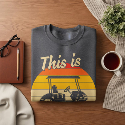 Dark gray sweatshirt with a vintage golf cart and sunset graphic and text.