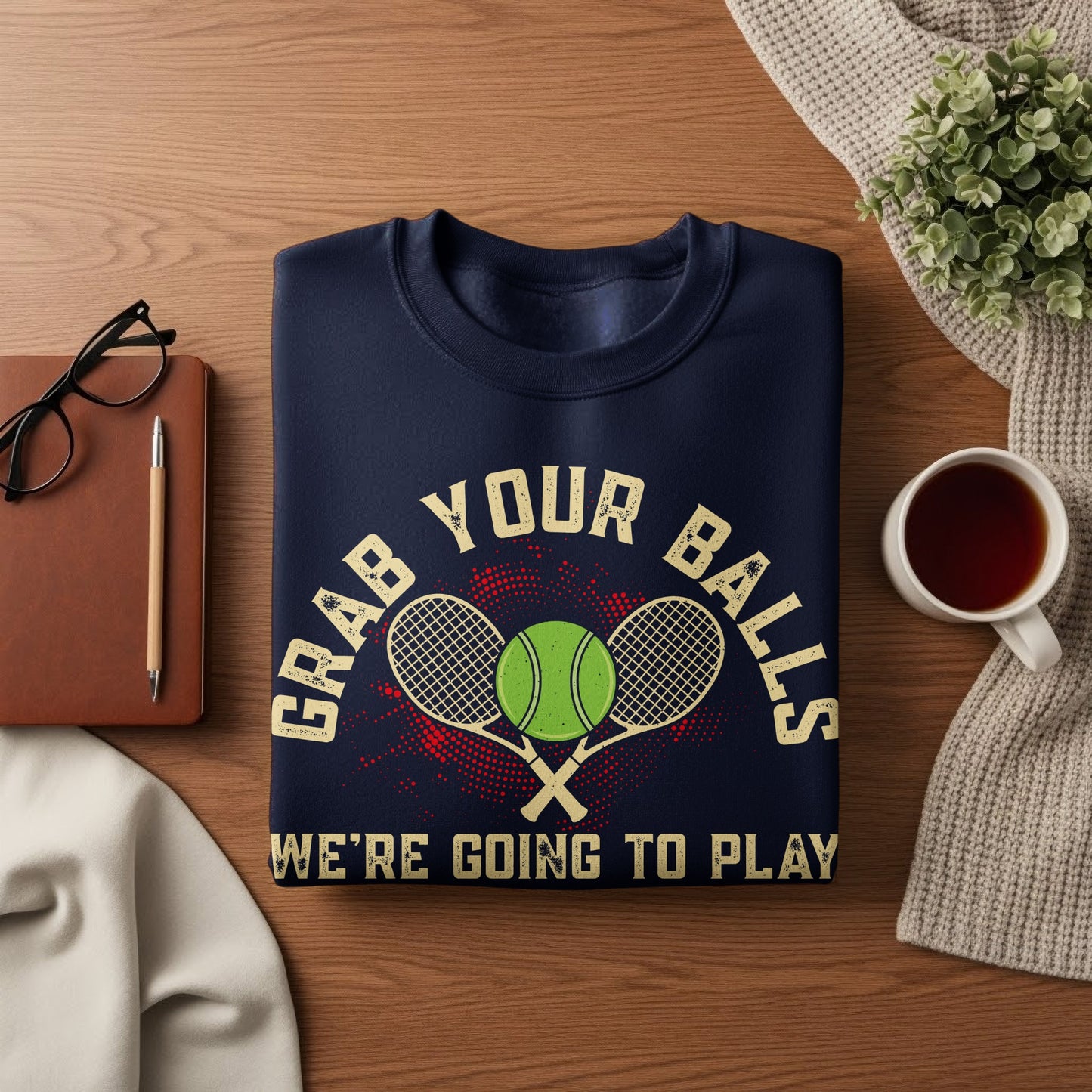Navy sweatshirt with "GRAB YOUR BALLS WE'RE GOING TO PLAY" and tennis graphics.