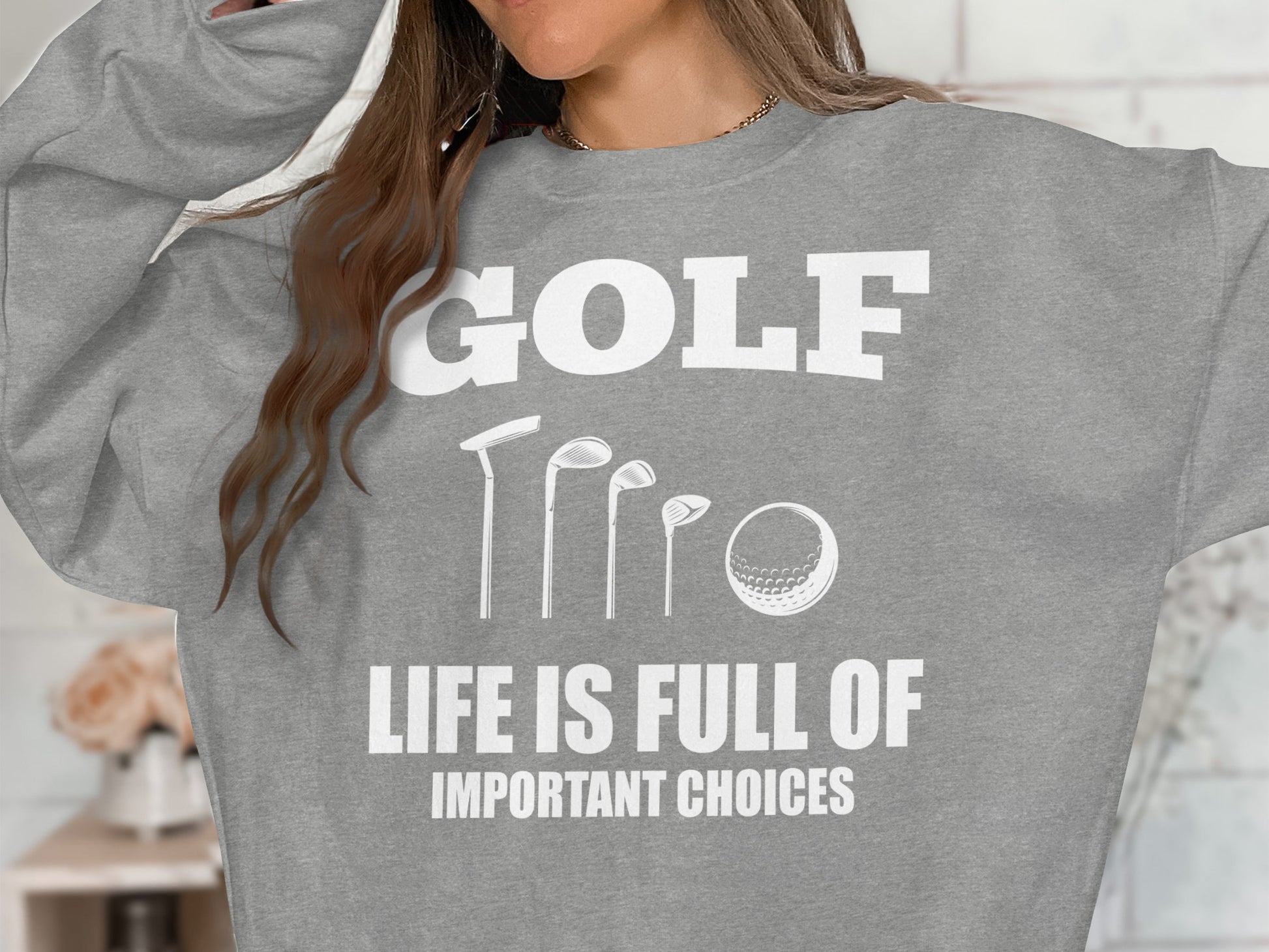 Grey sweatshirt with "GOLF LIFE IS FULL OF IMPORTANT CHOICES" and golf club graphics.