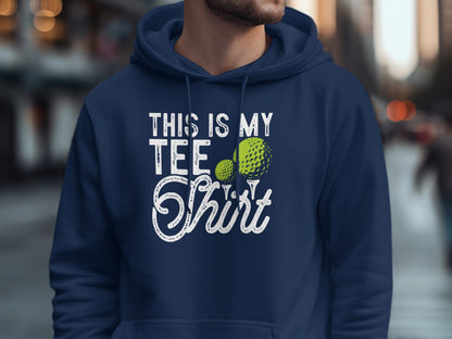 Navy hoodie with "This is my tee shirt" text and two golf balls.