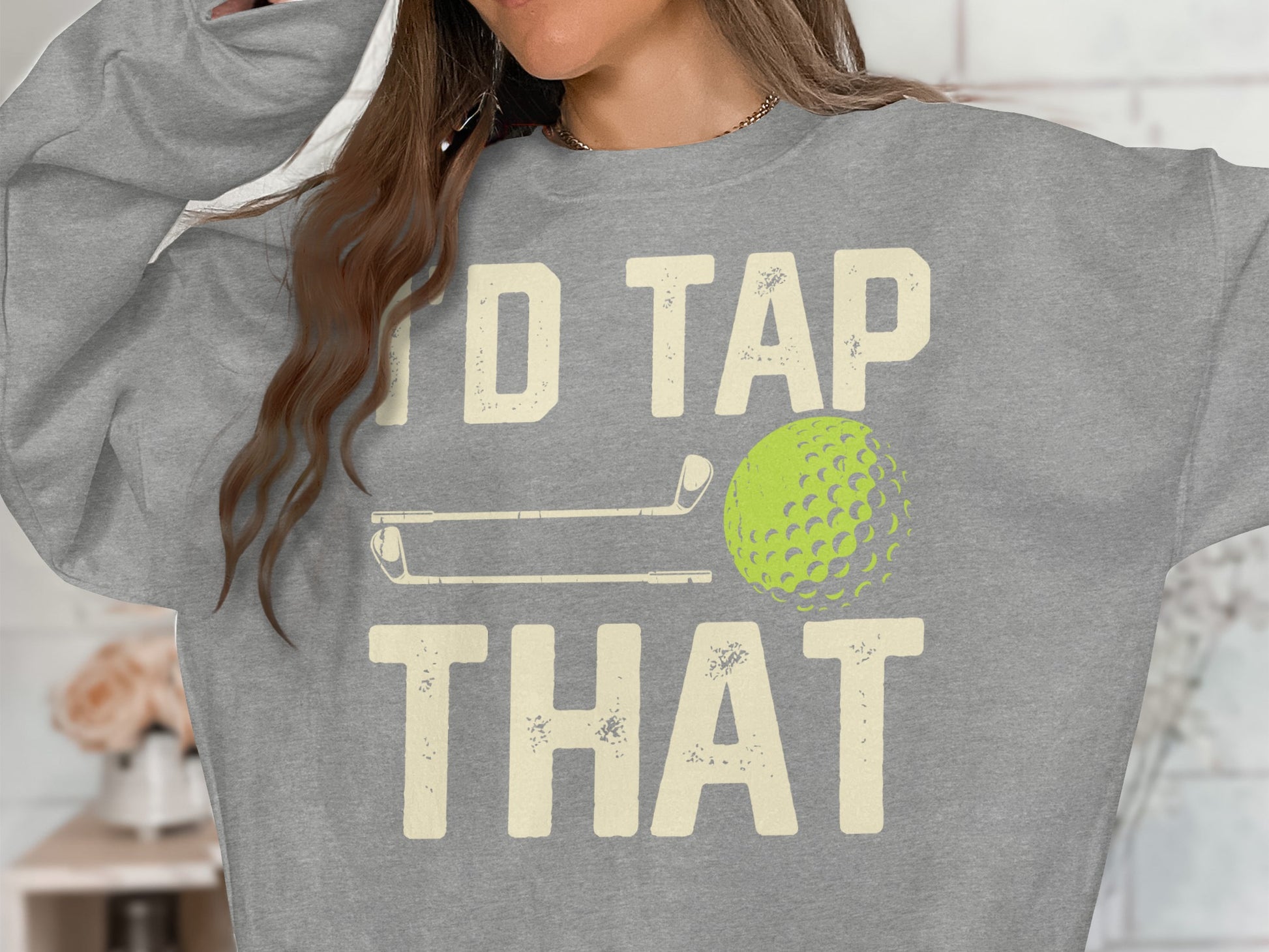 Gray sweatshirt with "I'd Tap That" text, golf club, and golf ball graphic.