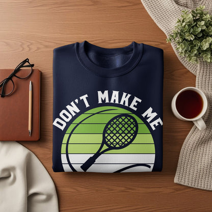Navy sweatshirt with "Don't Make Me" text and tennis racket graphic.