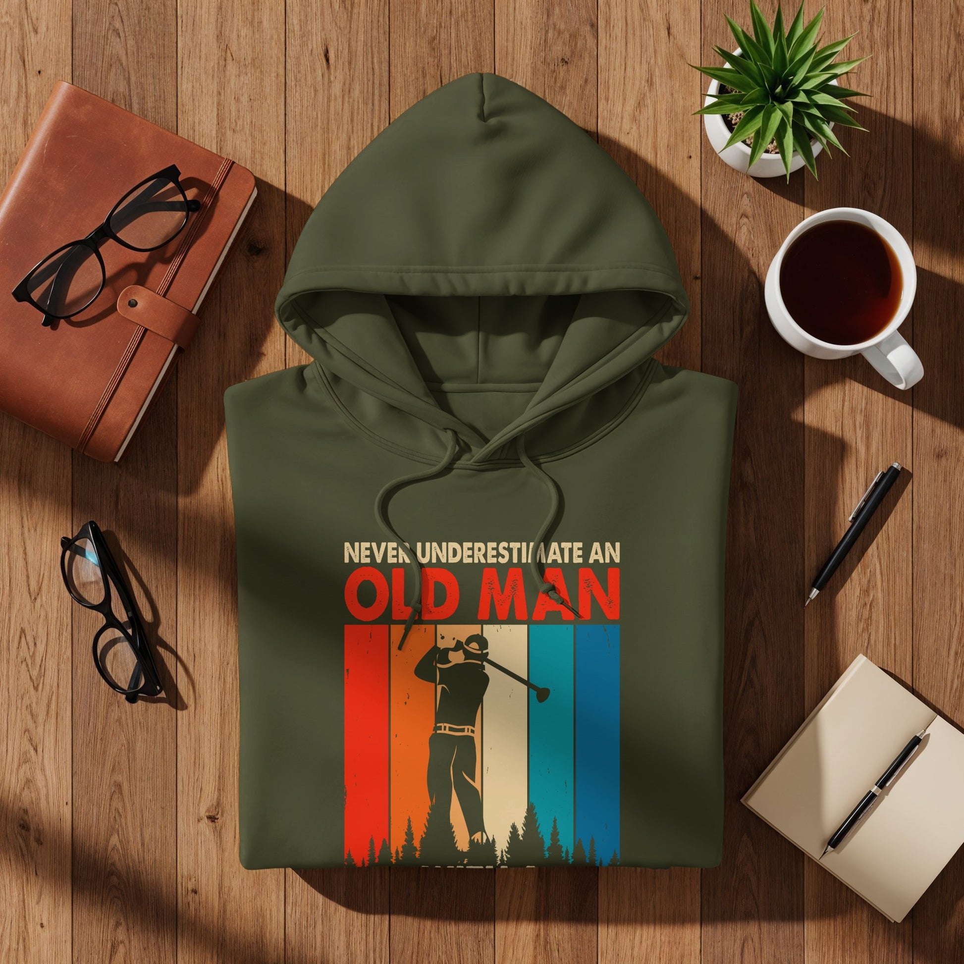 Olive green hoodie with "Never Underestimate An Old Man" graphic and golf design.