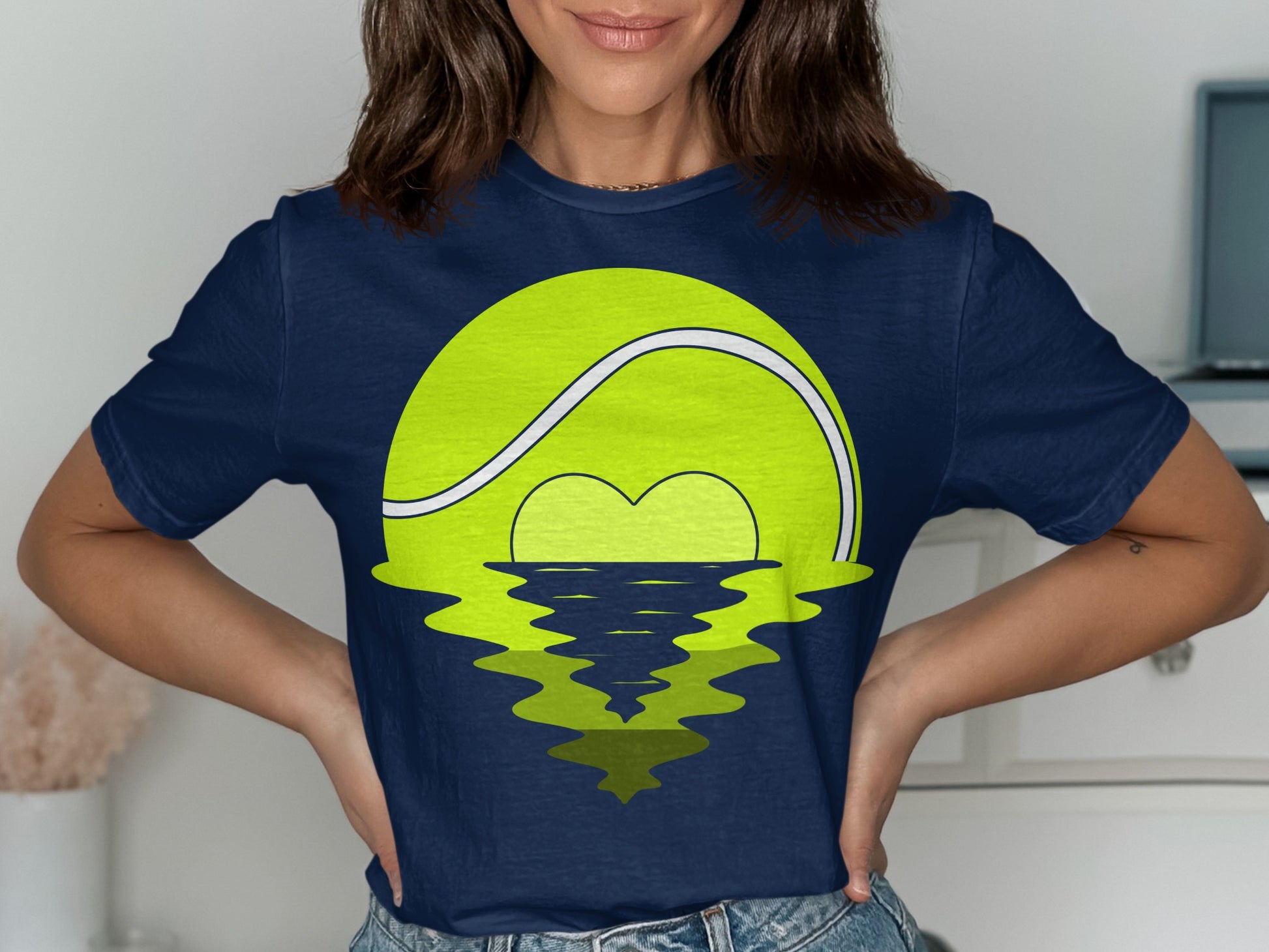 Navy t-shirt with a large tennis ball graphic reflecting on water.