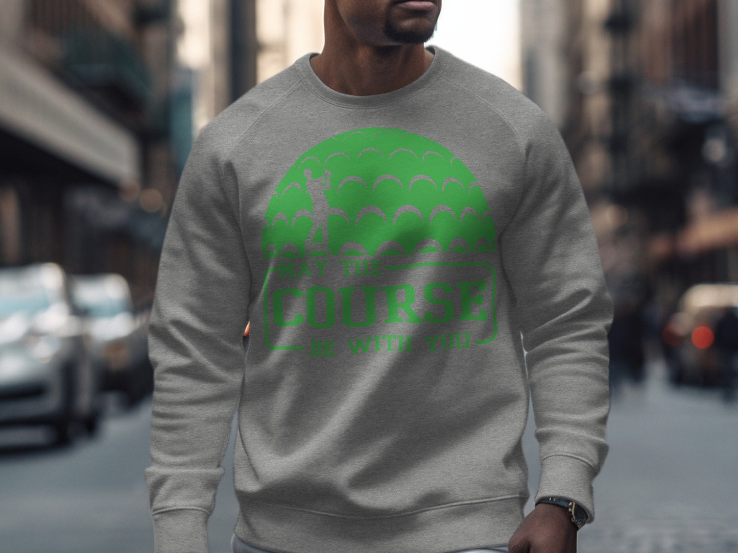 Gray sweatshirt with green golf ball pattern and "May the course be with you" text.