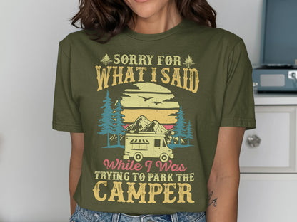 Olive green t-shirt with "Sorry for what I said while parking the camper" text and mountain scene.