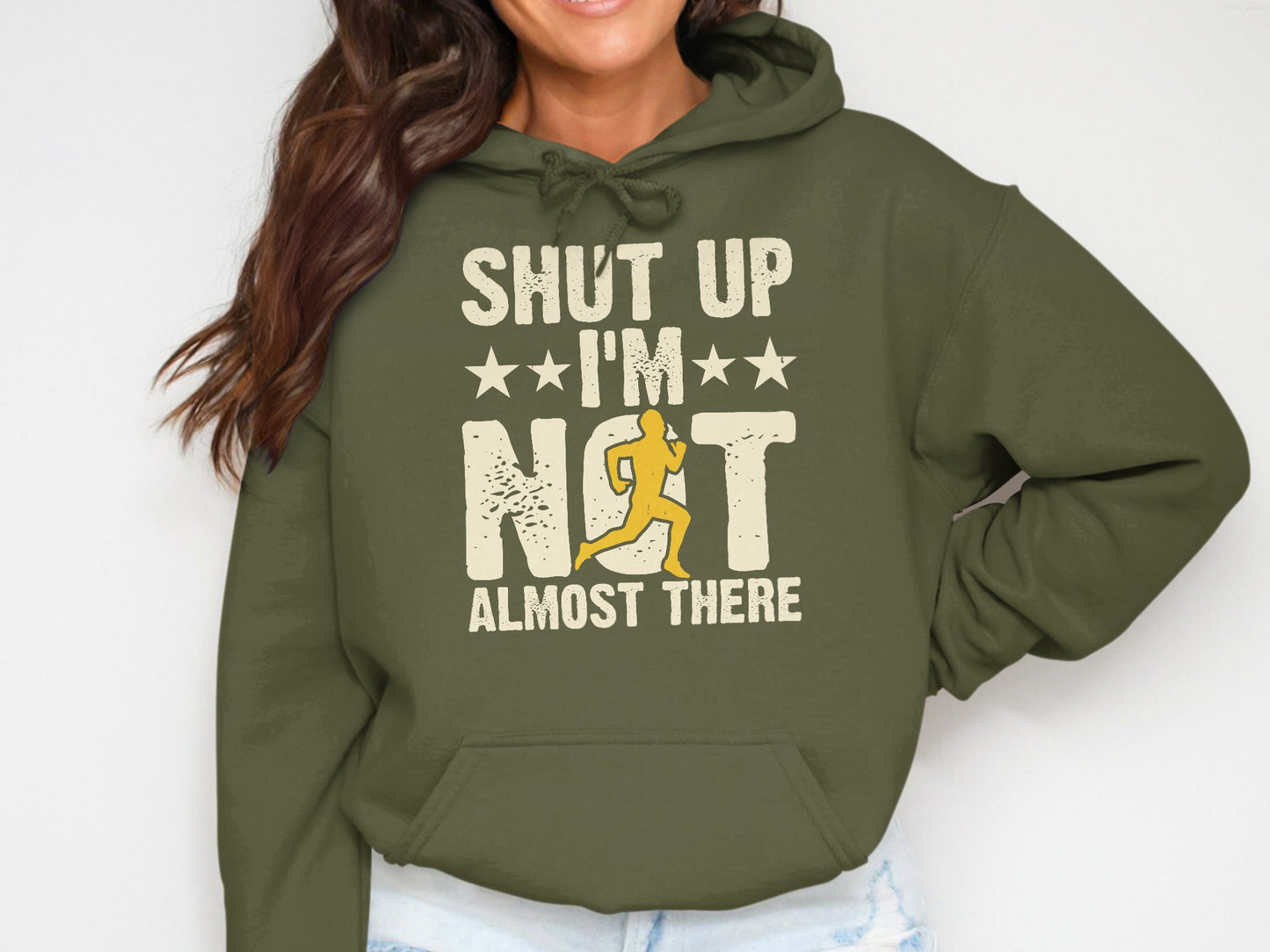 Olive green hoodie with "Shut Up I'm Not Almost There" text and running figure.