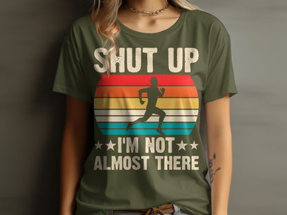 Green t-shirt with runner and "Shut Up I'm Not Almost There" text.