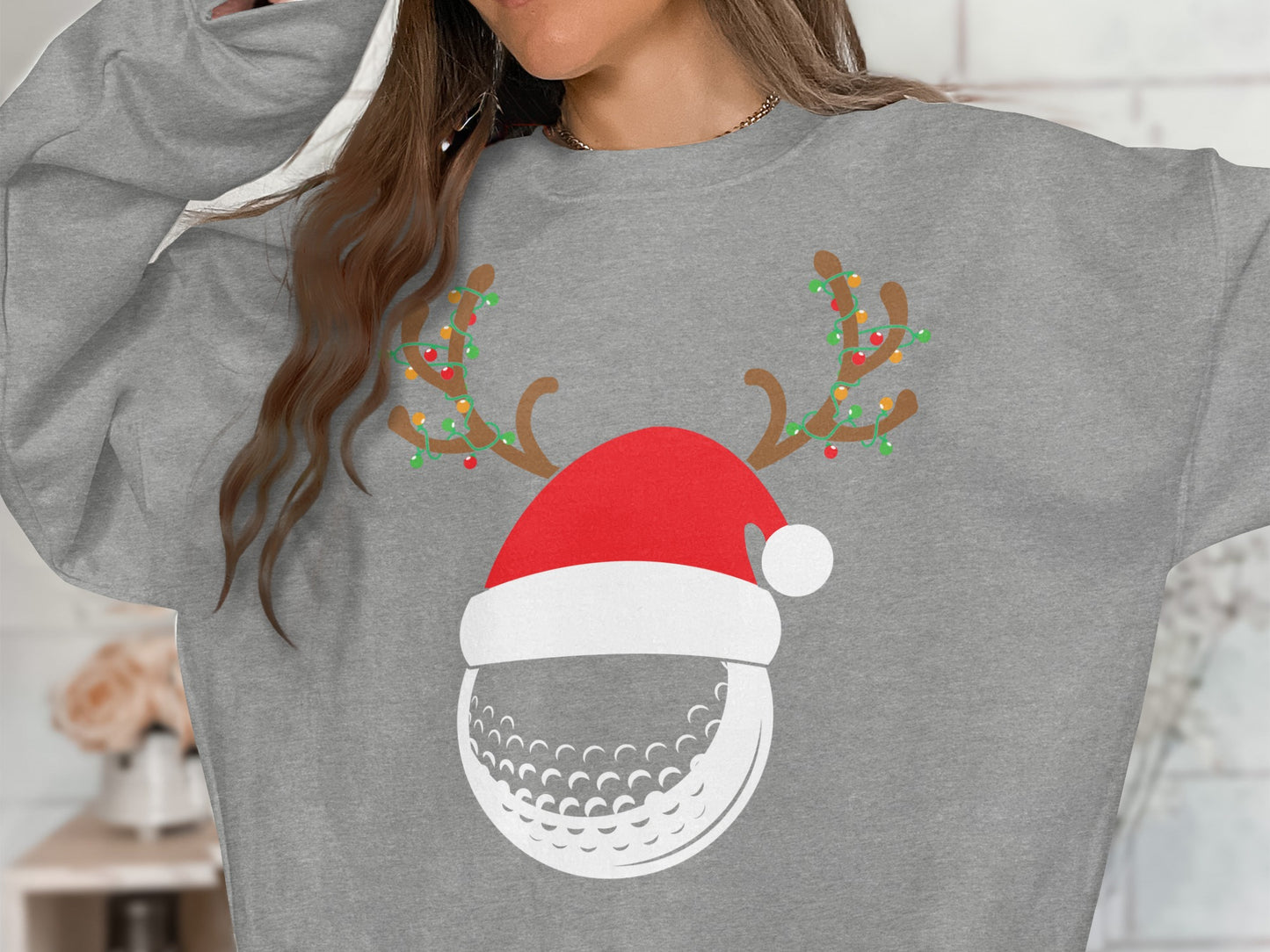 Grey sweatshirt with a Christmas-themed golf ball graphic.